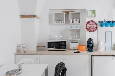 a kitchen with a counter with a microwave on it at Coronari stylish apartment in Rome