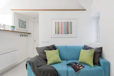 a blue couch with pillows in a living room at Coronari stylish apartment in Rome