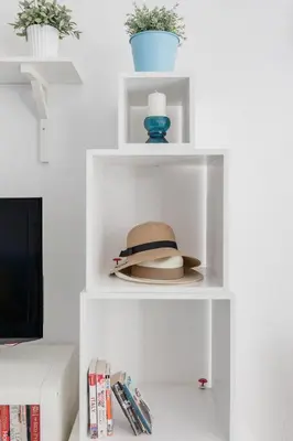 a hat is sitting on a white shelf at Coronari stylish apartment in Rome