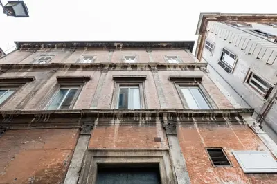 an old brick building with many windows on it at Coronari stylish apartment in Rome