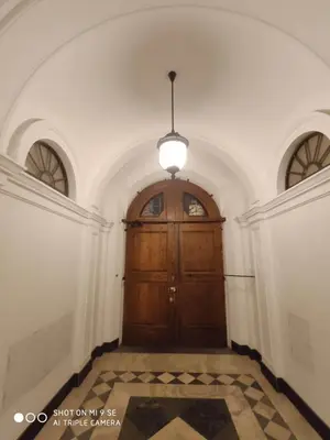 a large wooden door in a room with two windows at Double B Ferruccio I in Rome