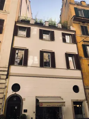 a large white building with black shuttered windows at Saint B Boutique Hotel STB in Rome