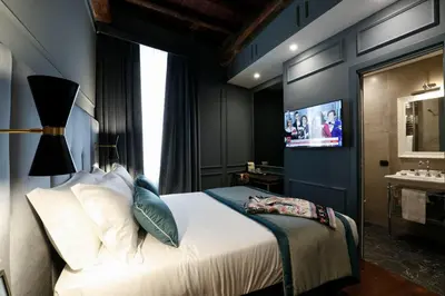 a hotel room with a bed and a tv at Saint B Boutique Hotel STB in Rome