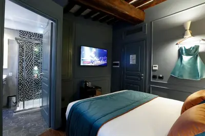 a bedroom with a bed and a tv on the wall at Saint B Boutique Hotel STB in Rome