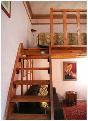 a bunk bed in a room with a ladder at 1A Grace House in Rome