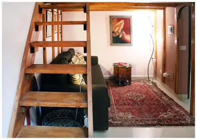 a loft bed in a living room with a staircase at 1A Grace House in Rome
