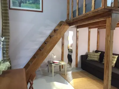 a living room with a staircase with a couch and a table at 1A Grace House in Rome