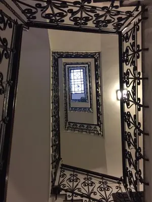 a mirror with a black frame and a window at 1A Grace House in Rome