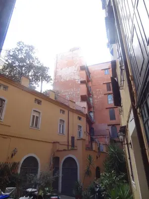 a group of buildings in a street with a building at 1A Grace House in Rome