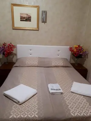 a bed with two white towels on top of it at Botel Inn in Rome