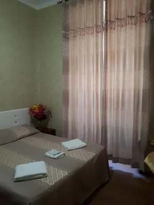 a bedroom with a bed with two towels on it at Botel Inn in Rome