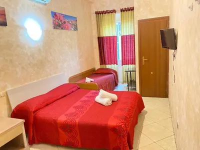 a hotel room with two beds and a television at Botel Inn in Rome