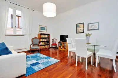 a living room with a table and white chairs at RomeAsYouLike-Monti Experience 295 in Rome