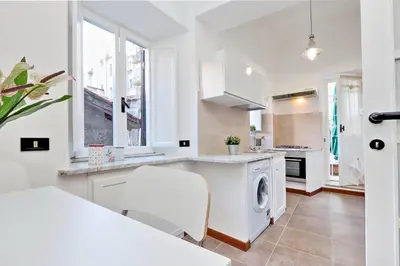 a white kitchen with a washer and dryer at RomeAsYouLike-Monti Experience 295 in Rome
