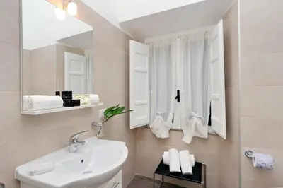a bathroom with a sink and a mirror at RomeAsYouLike-Monti Experience 295 in Rome