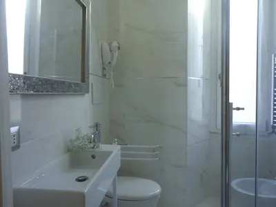 a bedroom with a bed next to a window at Cameo B&B in Rome