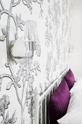 a bedroom with a table with a mirror and a vase of flowers at Cameo B&B in Rome