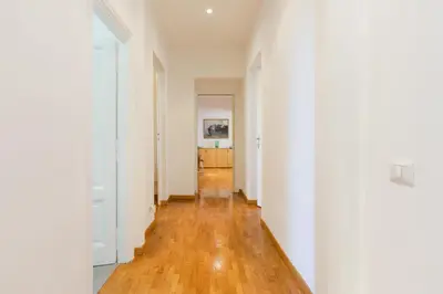 an empty hallway with white walls and wood floors at Domus Mari in Rome