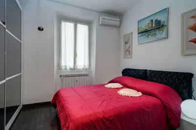 a bedroom with a red bed with a red blanket at Mammamia in Rome