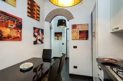 a kitchen with a table and a white door at Mammamia in Rome