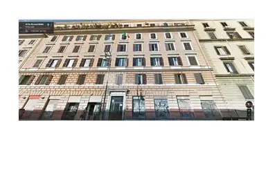 a tall building with a bunch of windows on it at Mammamia in Rome