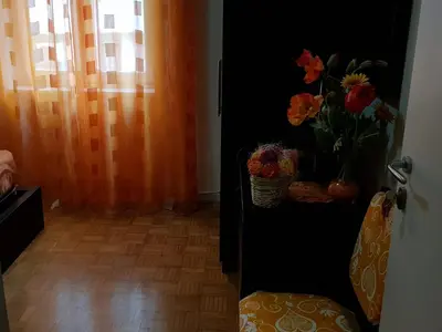 a room with a black cabinet with a vase of flowers at Domina Romae B&B in Rome