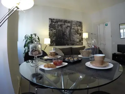 a glass table with food on it in a living room at Banchi Vecchi NY in Rome
