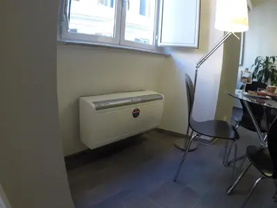 a small room with a table and a window and a heater at Banchi Vecchi NY in Rome