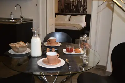a table with two cups and plates of food on it at Banchi Vecchi NY in Rome