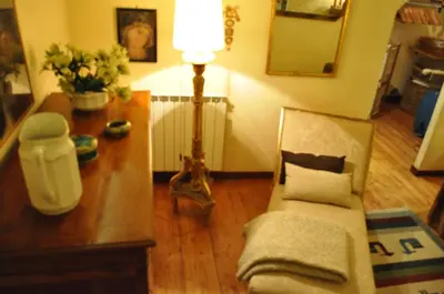 a living room with a couch and a table with a lamp at Onofrio Flat in Rome