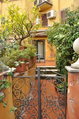 an entrance to a building with a gate with plants at Onofrio Flat in Rome