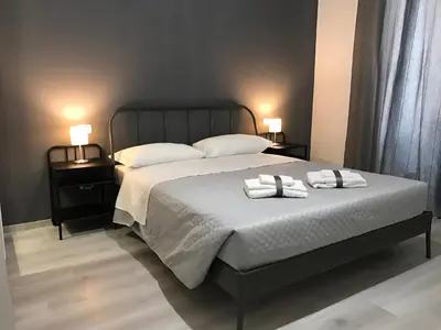 a bedroom with a bed with two towels on it at Sensation House in Rome