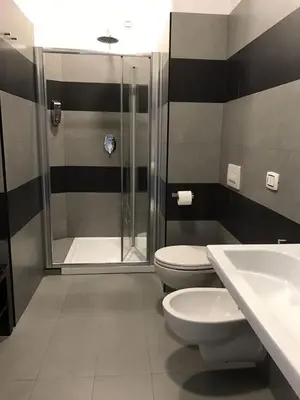 a bathroom with a shower and a toilet and a sink at Sensation House in Rome