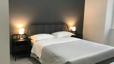 a bedroom with a large bed with two night stands at Sensation House in Rome