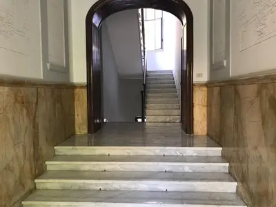 a hallway with stairs leading up to a building at Sensation House in Rome