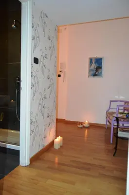 a room with a wall with a candle on the floor at Blue Star luxury apartment San Giovanni - Colosseo in Rome