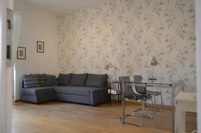 a living room with a couch and a table with chairs at Blue Star luxury apartment San Giovanni - Colosseo in Rome