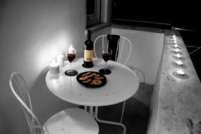 a white table with two glasses of wine and cookies at Blue Star luxury apartment San Giovanni - Colosseo in Rome