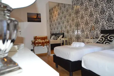 a hotel room with two beds and a mirror at Blue Star luxury apartment San Giovanni - Colosseo in Rome