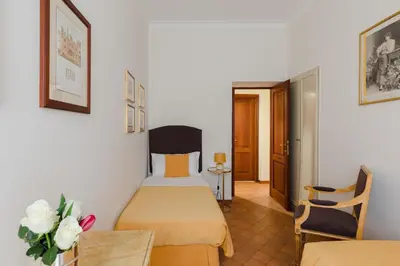 a hotel room with a bed and a table and chairs at Relais Rasella 47 in Rome