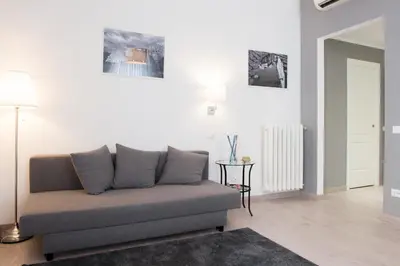 a living room with a couch and a table at Le Stanze Di Gaia in Rome