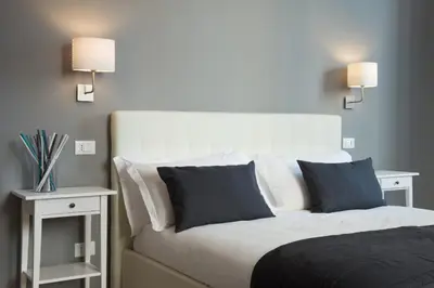 a bedroom with a bed with blue and white pillows at Le Stanze Di Gaia in Rome