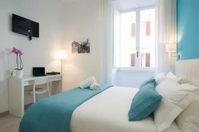 a bedroom with a bed with a desk and a window at Le Stanze Di Gaia in Rome