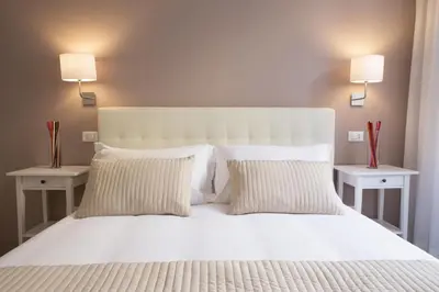 a bedroom with a white bed with two night stands at Le Stanze Di Gaia in Rome