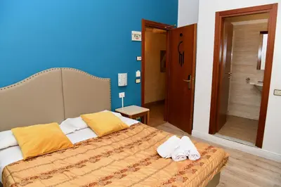 a bedroom with a bed with towels on it at Hotel Anacapri in Rome