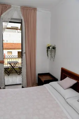 a bedroom with a bed and a view of a balcony at Hotel Anacapri in Rome