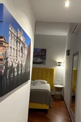 a bedroom with a bed and a picture on the wall at Vatican QG Rooms in Rome