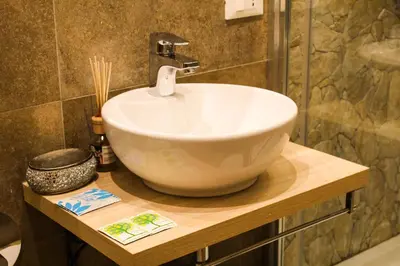 a bathroom with a white bowl sink on a counter at Vatican QG Rooms in Rome
