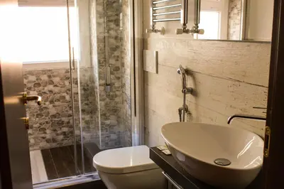 a bathroom with a sink and a toilet and a shower at Vatican QG Rooms in Rome