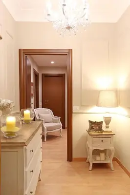 a living room with a table and a chandelier at Daplace - Ottavia Apartment in Rome